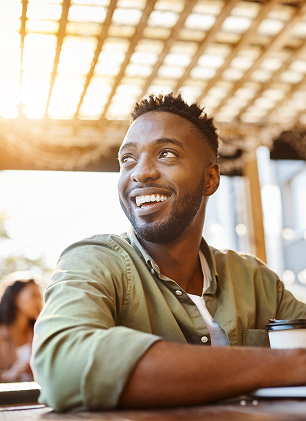 Man at outdoor cafe smiling